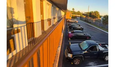 a black truck parked on a street next to a building at Central Motel Kissimmee Near Disney World in Kissimmee