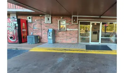 a brick building with two vending machines in front of it at Central Motel Kissimmee Near Disney World in Kissimmee