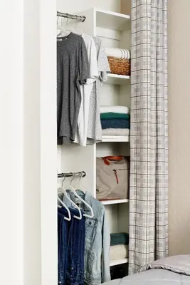 a closet filled with lots of clothes at InTown Suites Extended Stay Orlando FL - Universal in Orlando