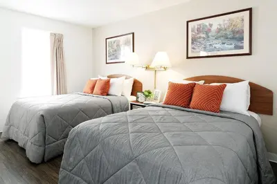 a hotel room with two beds and a window at InTown Suites Extended Stay Select Orlando FL - Lee Rd in Orlando