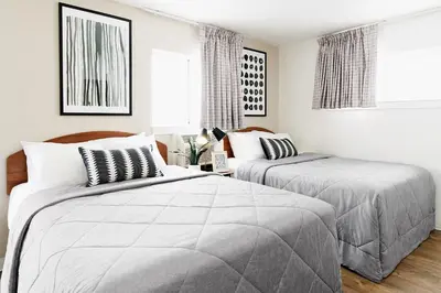 two beds in a bedroom with white walls at InTown Suites Extended Stay Select Orlando FL - Lee Rd in Orlando