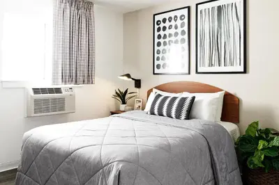 a bedroom with a bed and a window at InTown Suites Extended Stay Orlando FL - South in Orlando