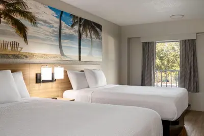 a hotel room with two beds and a window at Days Inn by Wyndham Apopka/Orlando in Orlando