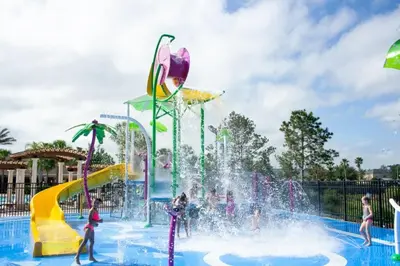 a water park with people playing in a fountain at Fantastic Condo - 2 Miles from Disney Pool View Windsor Hills in Orlando