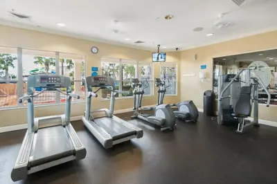 a gym with treadmills and elliptical machines at Fantastic Condo - 2 Miles from Disney Pool View Windsor Hills in Orlando