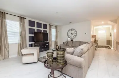 a living room with a couch and a table at Enchanting Escape Private Pool SPA Games Room in Orlando