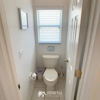 a small bathroom with a toilet and a window at Affordable Luxury Home Near Walt Disney World - Sunshine Villa at Glenbrook Resort, Orlando, Florida in Orlando