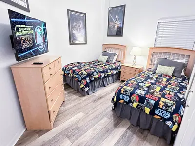 two beds and a dresser in a room with two beds sidx sidx at Affordable Luxury Home Near Walt Disney World - Sunshine Villa at Glenbrook Resort, Orlando, Florida in Orlando