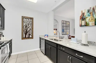 a kitchen with a sink and a counter top at Ground-Floor Vista Cay Condo Near Clubhouse Pool in Orlando