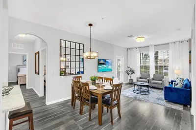 a dining room and living room with a table and chairs at Ground-Floor Vista Cay Condo Near Clubhouse Pool in Orlando