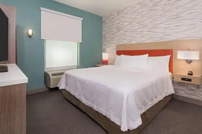 a hotel room with a large bed and a window at Home2 Suites By Hilton Orlando Near UCF in Orlando