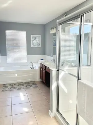 a bathroom with a shower and a tub and a sink at My Disney Castle in Orlando