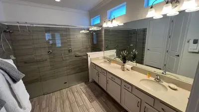 a bathroom with two sinks and a large mirror at 3830 Premier Villa 6Bd Private Pool and Game Room in Kissimmee