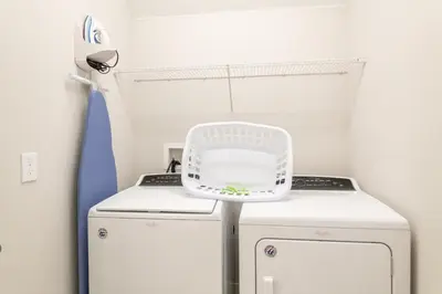 a small laundry room with two washer and dryer at Luxury Home With Themed Rooms, Air Hockey Near Disney With Waterpark & Resort Access At Encore Resort - 7699Gr in Kissimmee