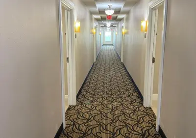 a hallway with a long hallway with a patterned floor at The Point Hotel & Suites - 705S Luxury - Pool view - Close to Universal in Orlando