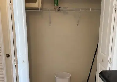 a bathroom with a closet with a trash can at The Point Hotel & Suites - 503 Luxury - Pool view - Close to Universal in Orlando