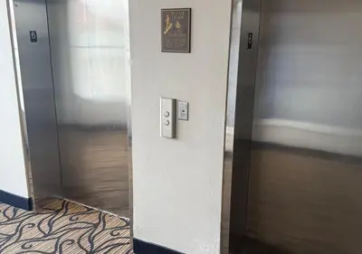 an elevator in a building with a sign on the wall at The Point Hotel & Suites - 503 Luxury - Pool view - Close to Universal in Orlando