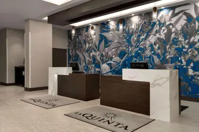 a lobby with a mural of flowers on the wall at La Quinta Inn & Suites by Wyndham Orlando I-Drive Theme Parks in Orlando