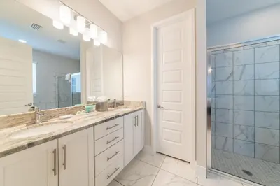 a bathroom with a double sink and a shower at Magnificent Home Near Disney With Theater Room, Pool Table, Waterpark & Resort Access At Encore Resort Reunion - 7448Mr in Kissimmee
