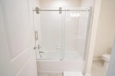 a glass shower in a bathroom with a toilet at Only 5 Miles from Disney! Free Water Park! 2 Bed, 2 Bath Condo, Sleeps 8 in Kissimmee