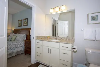 a bathroom with a sink and a bedroom with a bed at 2956 Lucaya Village - Gorgeous Four Bed Condo Close to Disney Area in Kissimmee