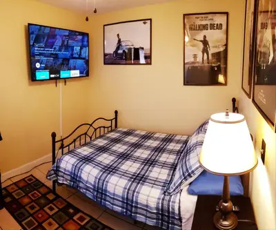 a bedroom with a bed and a flat screen tv at A1 Private Room With 55