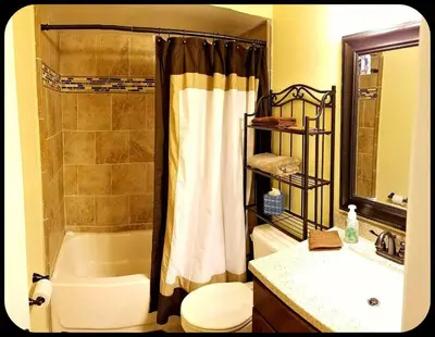 a bathroom with a tub and a toilet and a sink at A1 Private Room With 55
