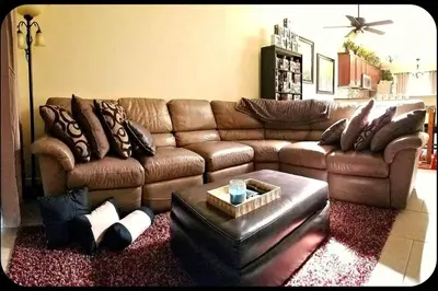 a living room with a brown leather couch at A1 Private Room With 55