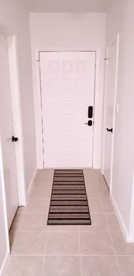 a white door with a rug in a hallway at D4 Large Private Master Room & Bath with 55