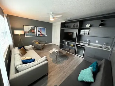 a living room with a couch and a tv at 3840 Supreme Villa 6Bd Private Pool and Game Room in Kissimmee