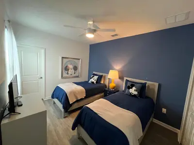 a bedroom with two beds and a ceiling fan at 3840 Supreme Villa 6Bd Private Pool and Game Room in Kissimmee