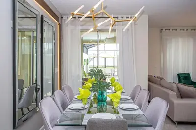 a dining room with a table with yellow flowers on it at Gorgeous 4 Bedroom w/ Pool Close to Disney 4836 in Kissimmee