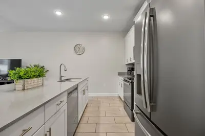 a kitchen with a stainless steel refrigerator at Renewed Luxury Townhouse with private pool in Kissimmee