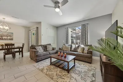 a living room with a couch and a table at Renewed Luxury Townhouse with private pool in Kissimmee