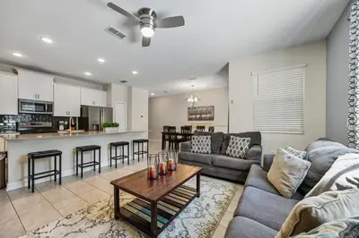 a living room with a couch and a table at Renewed Luxury Townhouse with private pool in Kissimmee