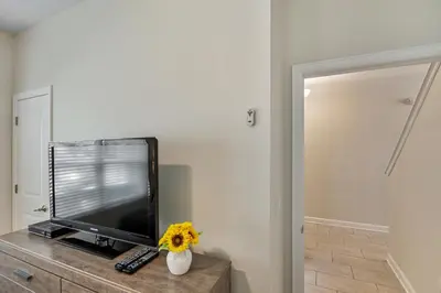 a flat screen tv sitting on top of a dresser at Renewed Luxury Townhouse with private pool in Kissimmee