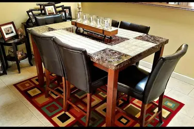 a dining room table with black chairs and a marble table at B2 Private Room With 55