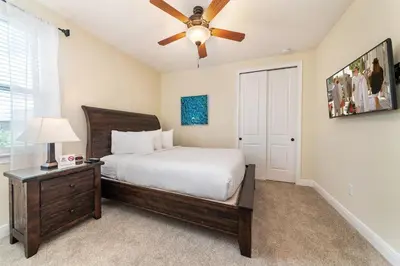 a bedroom with a bed and a ceiling fan at Elegant Home Near Disney With Private Pool And Waterpark & Resort Access At Encore Resorts Reunion - 430La in Kissimmee