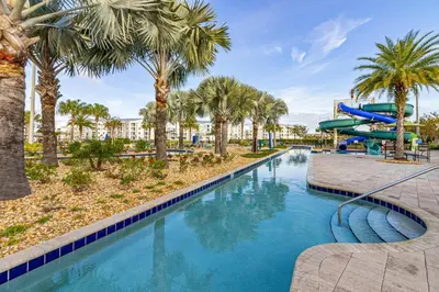a pool with a water slide at a resort at Storey Lake - Private Pool Home 10 Min to Disney in Kissimmee