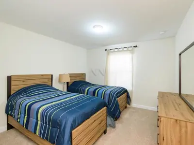 a bedroom with two beds and a tv in it at Storey Lake - Private Pool Home 10 Min to Disney in Kissimmee