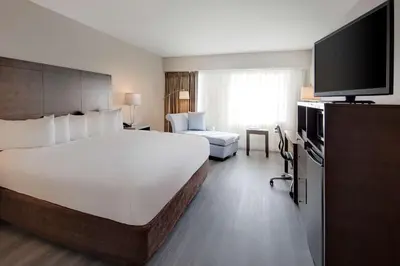 a hotel room with a large bed and a television at The Florida Hotel & Conference Center in the Florida Mall in Orlando