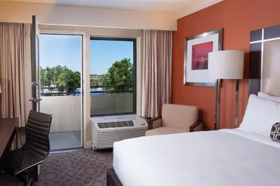 a hotel room with a bed and a large window at Delta Hotels by Marriott Orlando Lake Buena Vista in Orlando