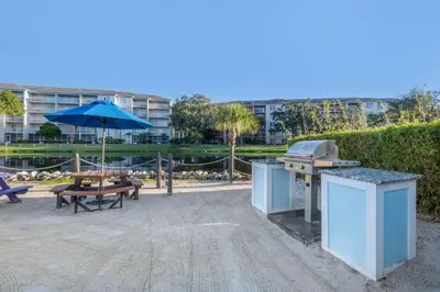 a grill and a picnic table with an umbrella at Hilton Vacation Club Aqua Sol Orlando West in Orlando