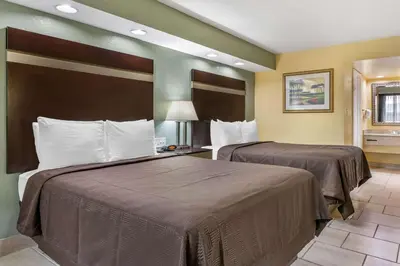 a hotel room with two beds in a room at Clarion Inn Orlando International Drive - ICON Park in Orlando