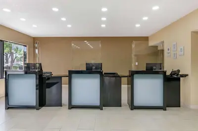 a lobby with two desks with computers on them at Clarion Inn Orlando International Drive - ICON Park in Orlando