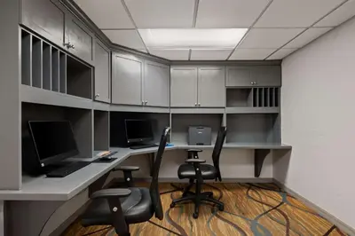 an office with two desks with computers and chairs at Best Western Orlando Gateway Hotel in Orlando