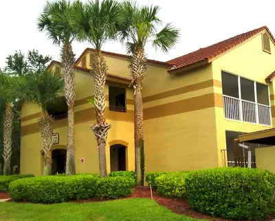 a house with palm trees in front of it at Blue Tree Resort at Lake Buena Vista in Orlando