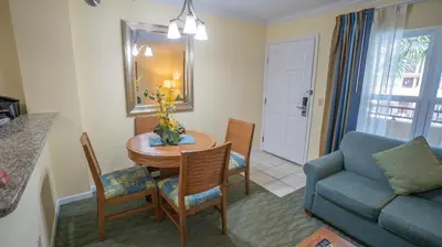 a living room with a table and a blue couch at Blue Tree Resort at Lake Buena Vista in Orlando