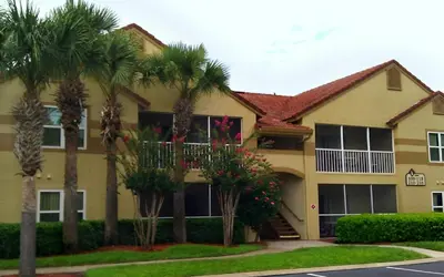a house with palm trees in front of it at Blue Tree Resort at Lake Buena Vista in Orlando