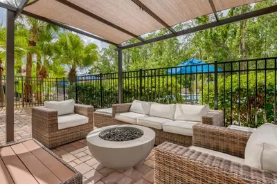 a patio with a couch and a table and chairs at Parkway International Resort in Orlando